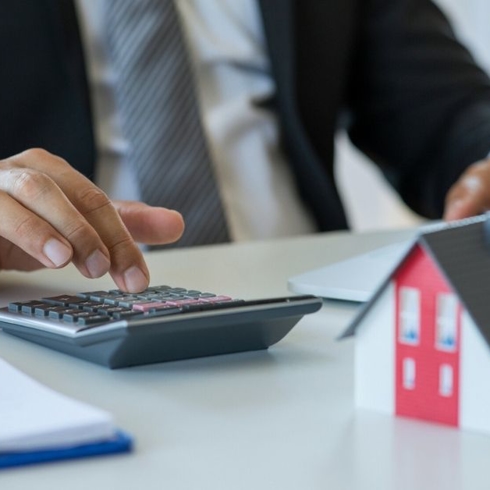 Realtor calculating the impact water damage has on the value of a client's home.